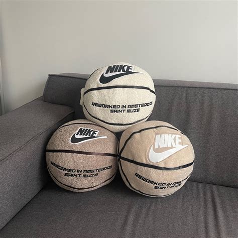 Three Nike Basketballs Sitting On Top Of A Couch