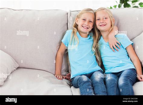 Blonde Twins Sitting On A Couch Stock Photo Alamy