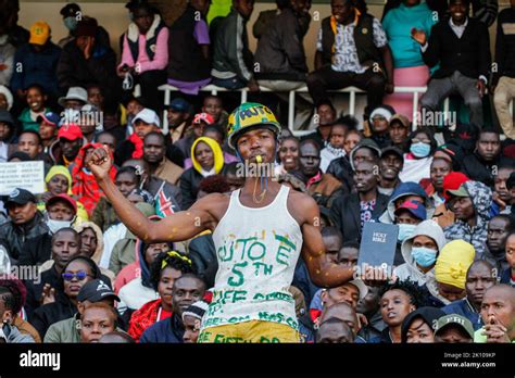 A Kenyan Man C Displays A Bible And Clenches His Fist As A Sign Of