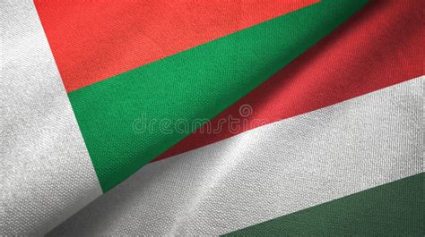 Madagascar And Hungary Two Flags Textile Cloth Fabric Texture Stock