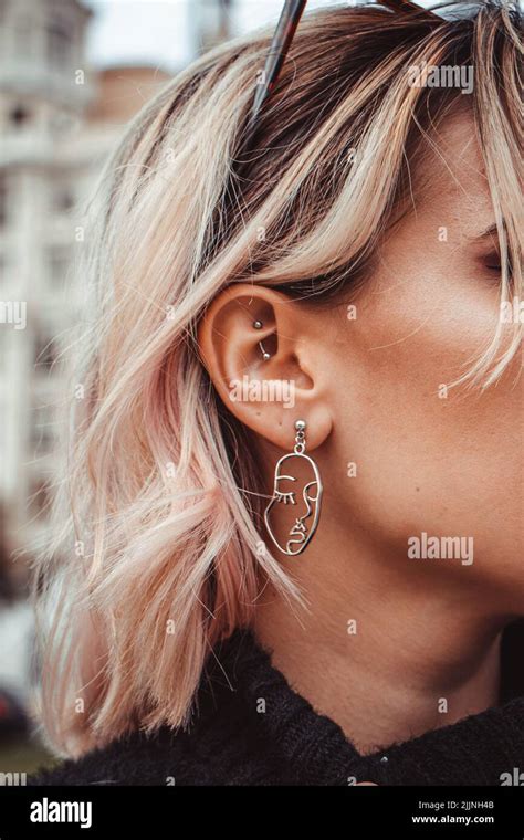 A Vertical Side View Of A Female Wearing Handmade Earrings Stock Photo