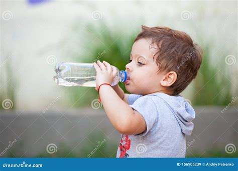 Boy Drinking Water from a Bottle Stock Image - Image of blue, hand: 156505239