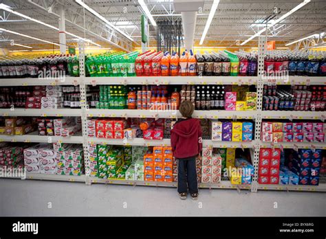 Seven year old boy stands in front of a giant aisle of soda, kool Stock ...