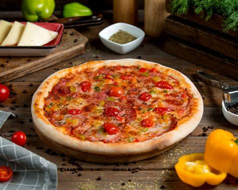 Free Photo Pepperoni Pizza With Tomato Bell Peppers Herbs And Cheese