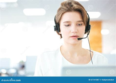 Serious Pretty Young Woman Working As Support Phone Operator Stock