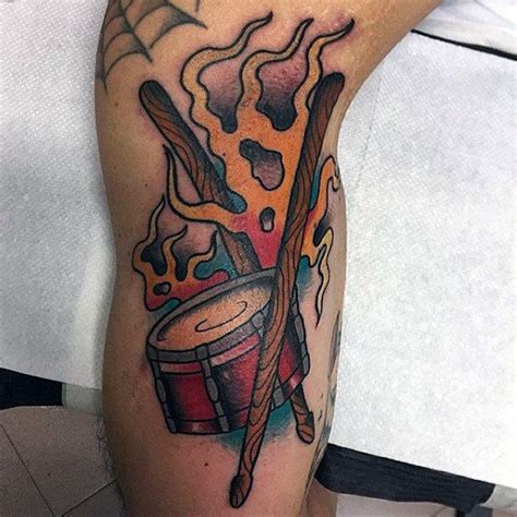 Male Arm Tattoo Of Drums With Sticks And Flames Drum Stick Tattoo Drum