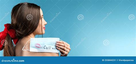 Side View Photo Of A Pretty Brunette Girl With Hair Tail Tied Up With A Red Ribbon Holding On