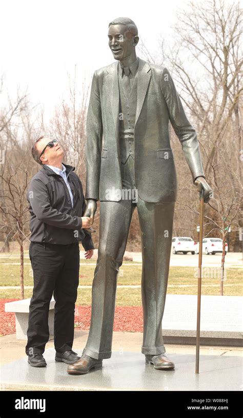 A Visitor To The Life Size Statue Of Robert Pershing Wadlow Compares