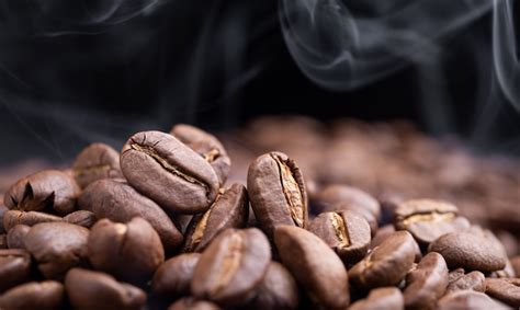 Premium Photo | Aroma roasted coffee beans on dark green