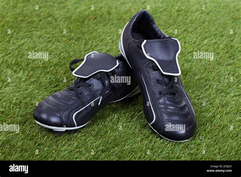 Pair Of Soccer Shoes On Grass Field Stock Photo - Alamy