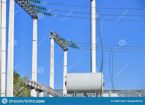 High Voltage Electricity Pylons Against Perfect Blue Sky With White