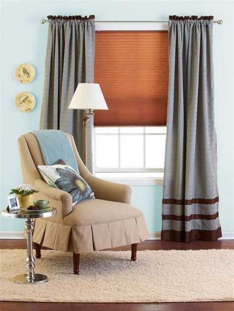 A Chair In Front Of A Window With A Lamp On The Side Table Next To It