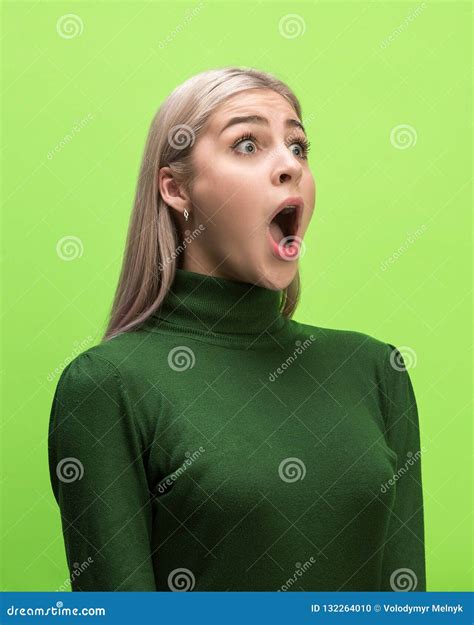 The Woman Screaming With Open Mouth Isolated On Green Background