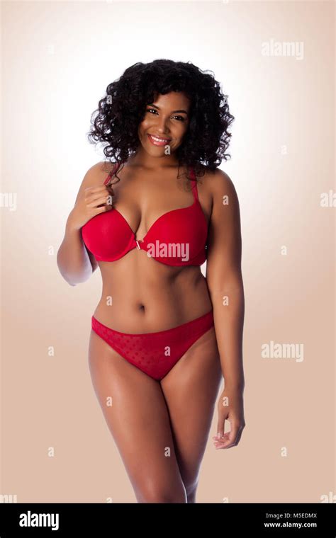 Beautiful Happy Plus Size Sexy Woman With Curly Hair In Red Lingerie