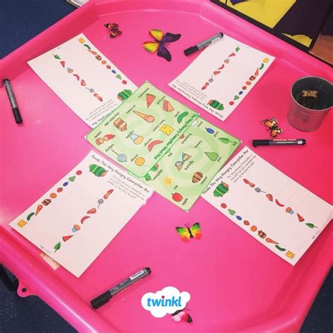 A Pink Tray Topped With Lots Of Cards And Markers