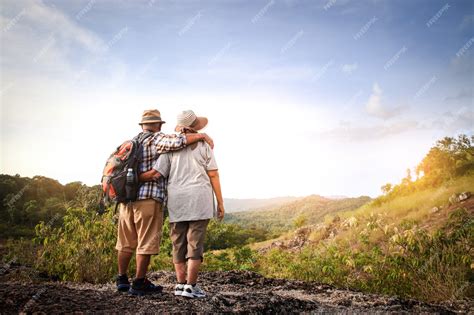 Premium Photo Elderly Couple Hiking And Standing On A High Mountain