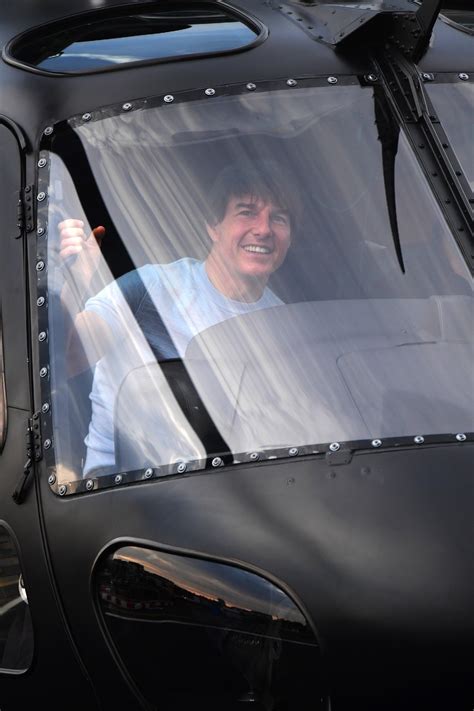 Tom Cruise flashes a big smile after flying himself in a helicopter
