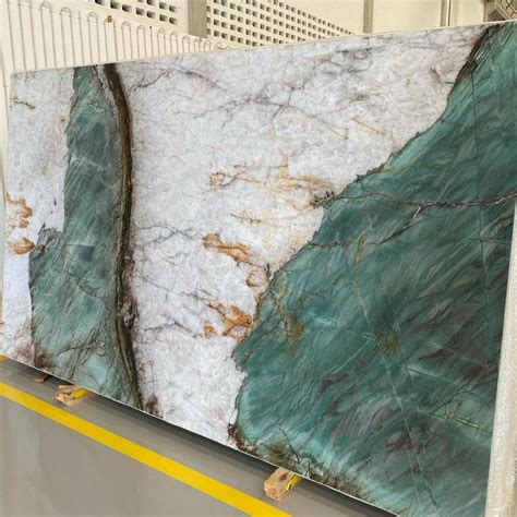 Two Large Marble Slabs Sitting On Top Of A Metal Shelf Next To Eachother