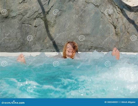 Portrait Of Laughing Beautiful Mature Natural Redhead Woman With Red Hair Stretches Her Feet Up