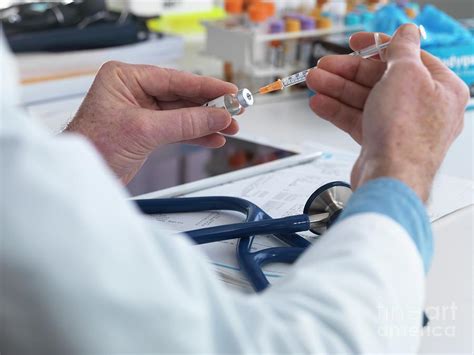 Doctor Preparing Injection Photograph By Tek Imagescience Photo