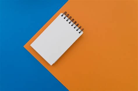 Free Photo Blank Notepad On Blue And Orange Background