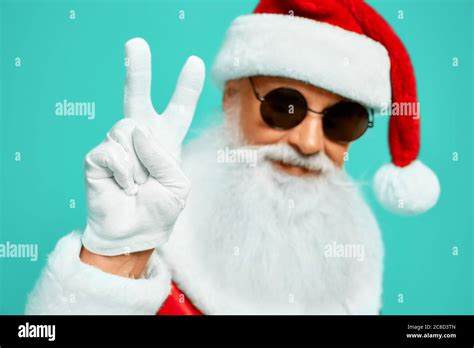 Front view of smiling Santa Claus with long white beard showing peace ...