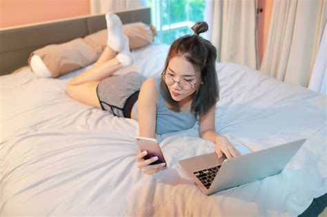 Premium Photo Beautiful And Sexy Woman Using Laptop Computer And Cell Phone Before Go To Sleep