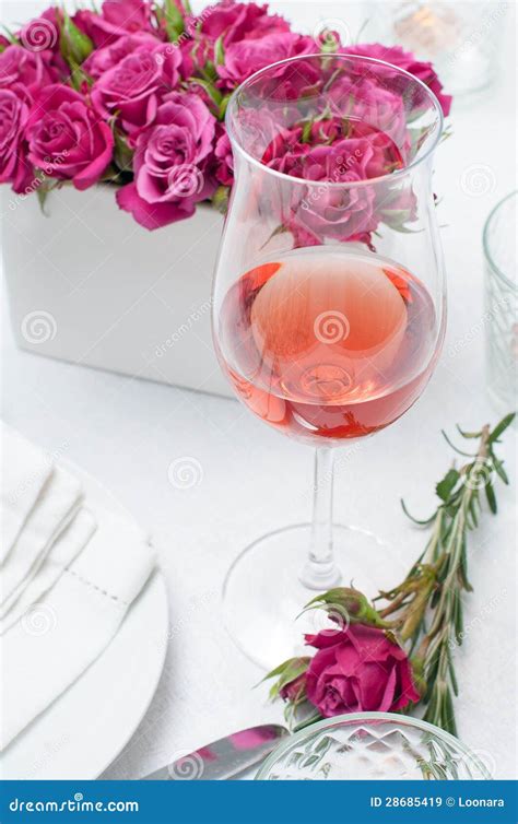 Glass Of Rose Wine And Festive Dining Table Setting With Pink Roses Stock Image Image Of