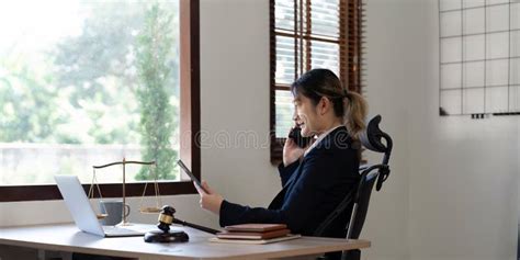 Attractive Young Lawyer In Office Business Woman And Lawyers Call Phone