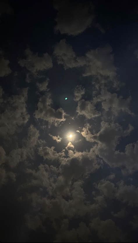 The Sun Is Shining Through Some Clouds In The Night Sky With Only One