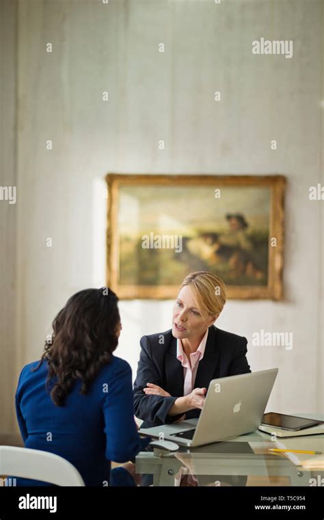 Businesswomen In Discussion With Client Stock Photo Alamy