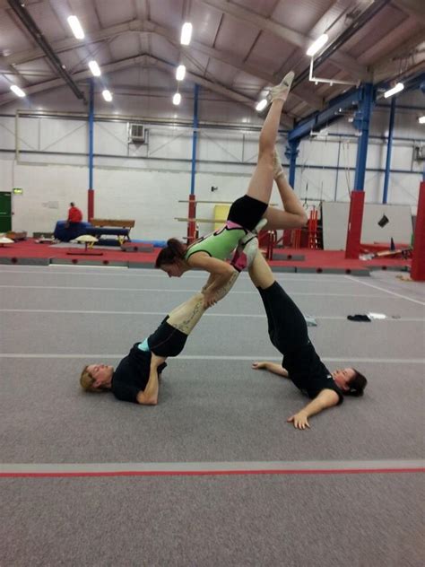 Two People Doing Handstands In An Indoor Gym