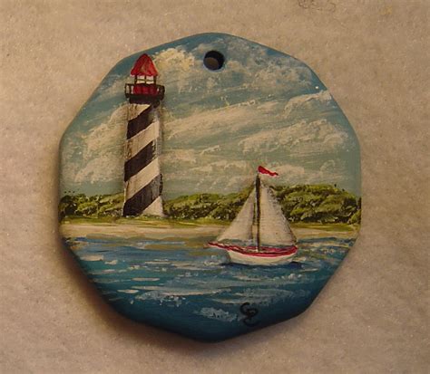 lighthouse with sailboat | Mandala painted rocks, Painted rocks diy, Pebble painting