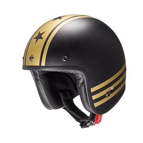 A Black And Gold Motorcycle Helmet With Stars On The Side Sitting