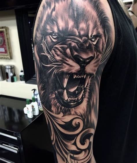 A Man With A Tattoo On His Arm Has A Tiger In It S Mouth