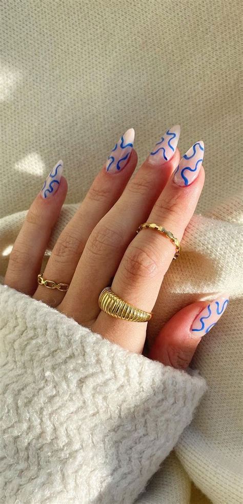 40 Awesome Nail Ideas You Should Try Blue Squiggle Nude Base Almond Nails
