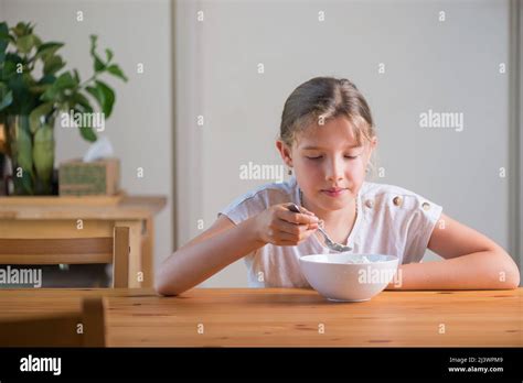 Blonde Teenage Girl Eating Cereal For Breakfast Lifestyle Portrait Stock Photo Alamy