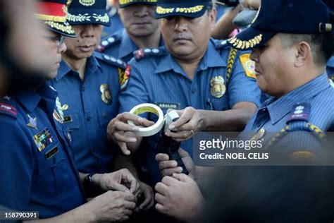 Members Of The Philippine National Police Force Seal The Muzzles Of