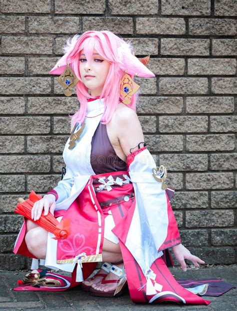 Female Cosplayer in a Pink Anime Costume Wearing Pink Hair Stock Photo ...