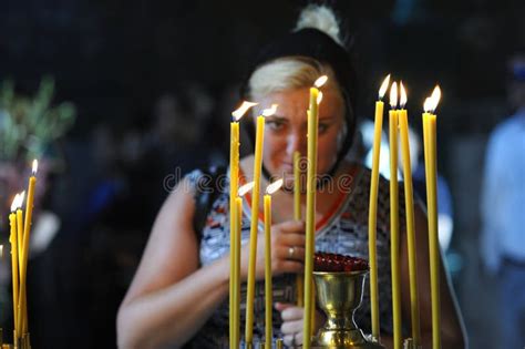 Old Woman Lighting Candles In A Church Editorial Photo Image Of