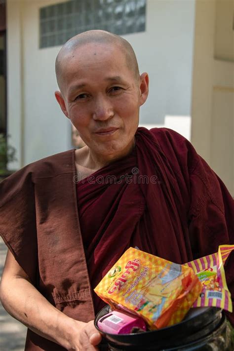 A Buddhist Monk Kneels In Prayer At The Shwedagon Pagoda Yangon