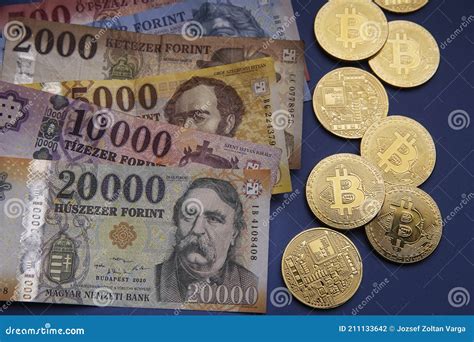 Several Hungarian Forint Paper Money Denominations With A Gold Bitcoin