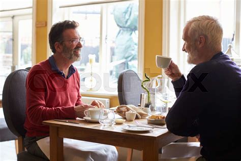 A Gay Male Couple Having Lunch In A Restaurant Side View Stock Image Colourbox