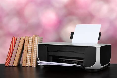 Premium Photo | Compact home printer on desk with books against blurred ...