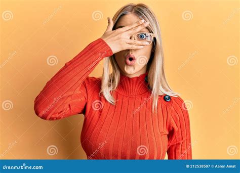 Beautiful Blonde Woman Wearing Casual Clothes And Glasses Peeking In