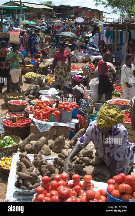 Traditional West African open air food market with market traders ...