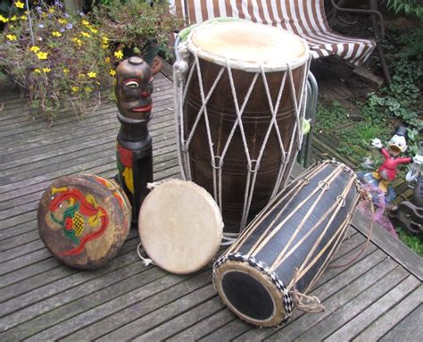 Four different drums + percussion instrument. - Catawiki