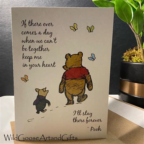 A Card With Winnie The Pooh And Piggy On It Next To A Potted Plant