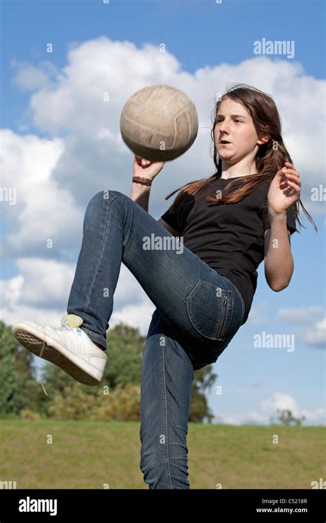 teenage girl practicing with a football Stock Photo - Alamy