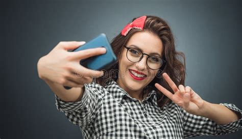 Young Woman Pointing Up With Forefinger To Copy Space Blank Space For